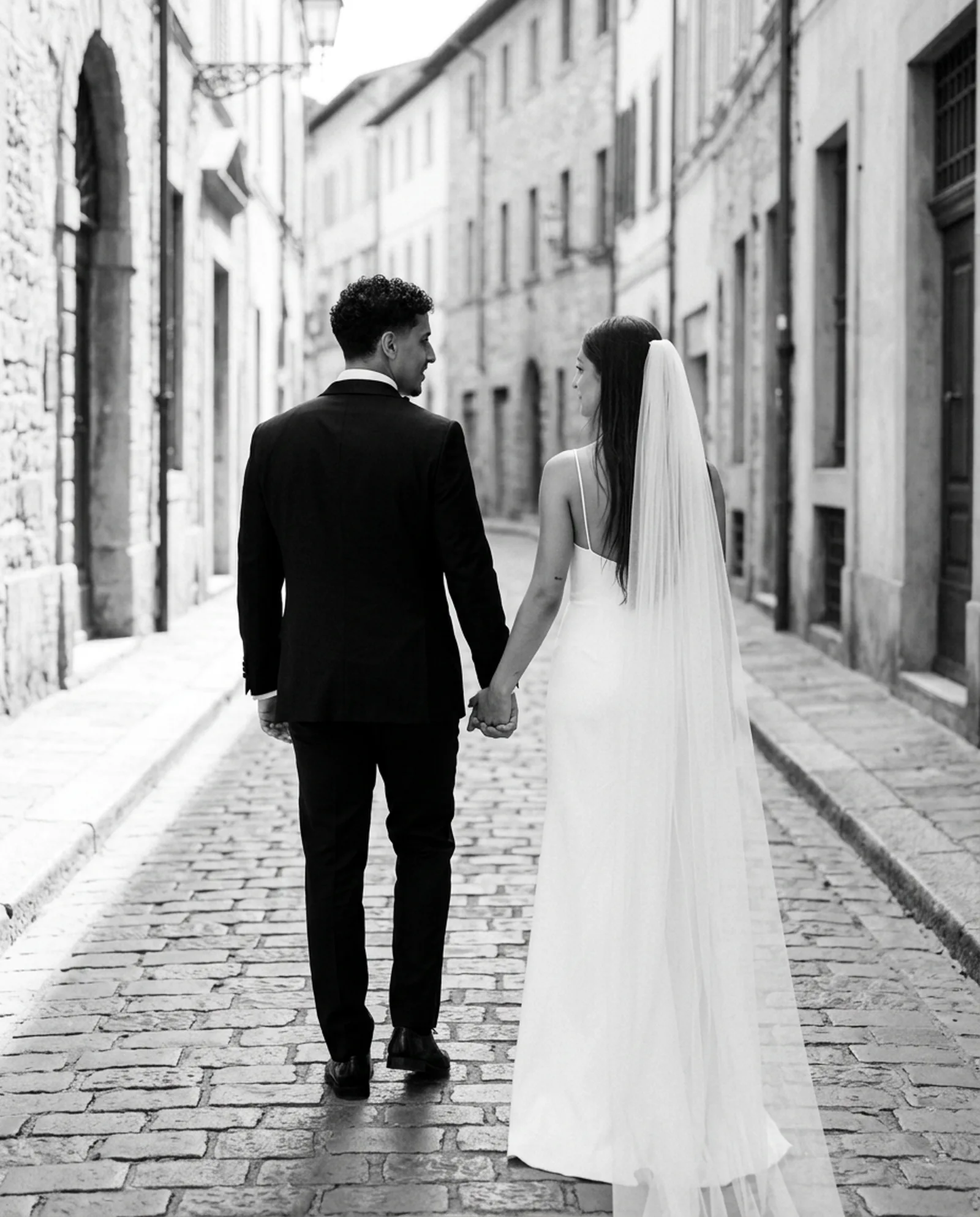 Casal caminhando em uma rua de pedra